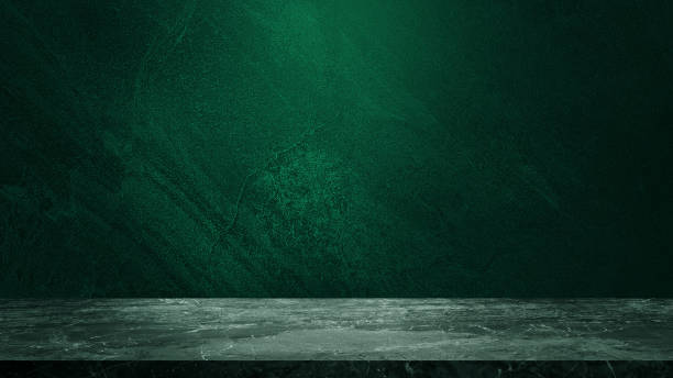 istock empty marble table at foreground and cement stone at background with green light from above for product displayed in rustic mood. green backdrop. abstract background for product stand for advertising. 1638642801