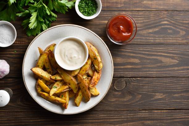istock Baked potato wedges with sauce 1638642802