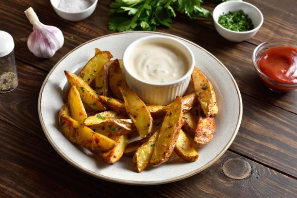 istock Baked potato wedges with sauce 1638642805