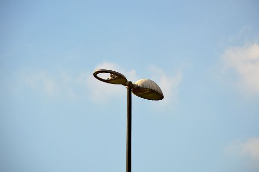 Old and broken street light with sky background