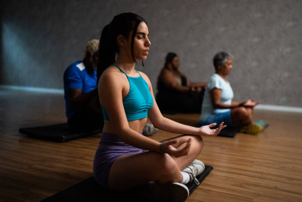 istock Young woman metitating at a gym 1638738507