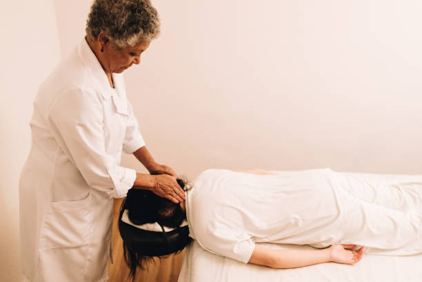 istock Therapist massaging a young woman at a spa 1638739596
