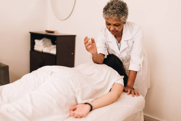 istock Therapist massaging a young woman at a spa 1638739599