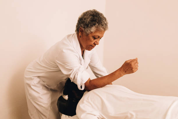 istock Therapist massaging a young woman at a spa 1638739601