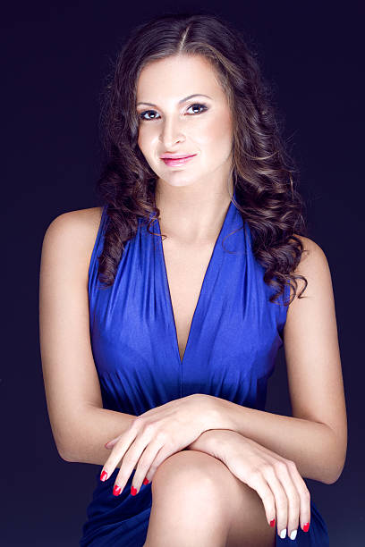 istock beautiful brunette in blue dress 163876013
