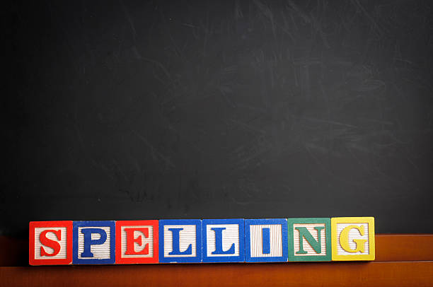 Spelling Class Stock photo of children's blocks spelling out the word spelling on a black board spelling bee stock pictures, royalty-free photos & images