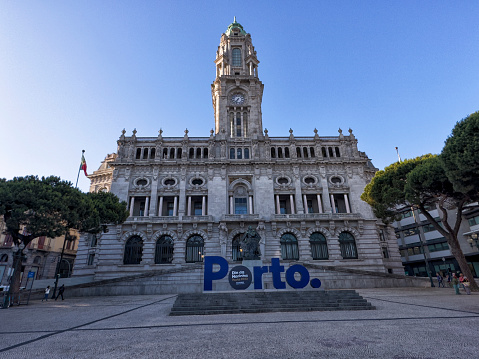 Exterior view of City Hall in the morning, Porto, Portugal. A blue Porto sign can be seen.