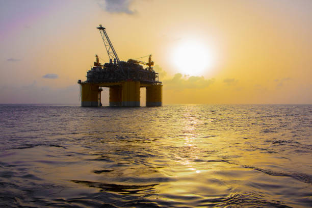 Offshore platform at sunset in Gulf of Mexico Offshore platform at sunset in Gulf of Mexico in United States, Louisiana, Gulf of Mexico gulf of mexico stock pictures, royalty-free photos & images