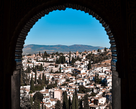 View of the Alhambra between houses in the Albaicín neighborhood. Granada.