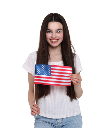 4th of July - Independence day of America. Happy teenage girl holding national flag of United States on white background