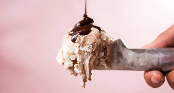 istock Hand holding an ice cream scoop with ice cream 1638782410