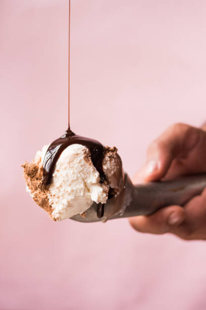 istock Hand holding an ice cream scoop with ice cream 1638782413