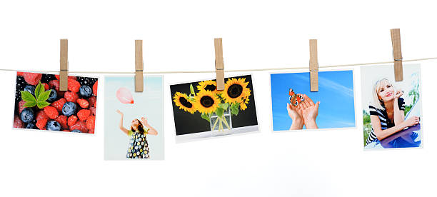 printed photos photos attached to a rope with clothespins printing out photos stock pictures, royalty-free photos & images