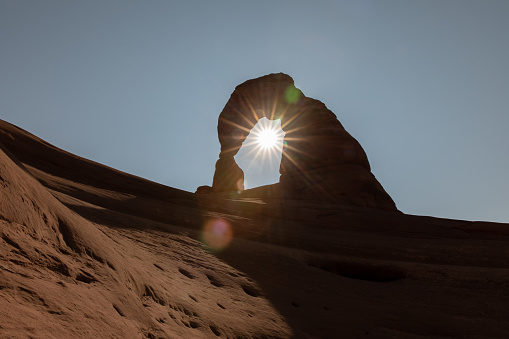 Sun Flare through Delicate Arch in Arches National Park, Utah in United States, Utah, Moab