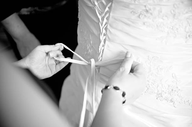 istock Bridesmaid helping to dress up 163878627