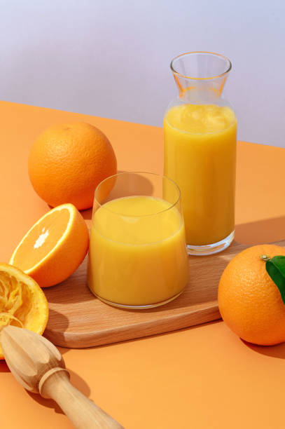 istock freshly squeezed juice on a bright orange background in a glass. 1638795626