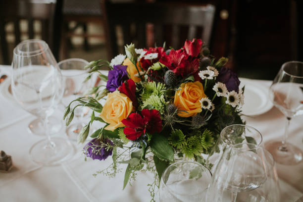 istock Colorful flowers as the centerpiece on a dining table surrounded 1638796850