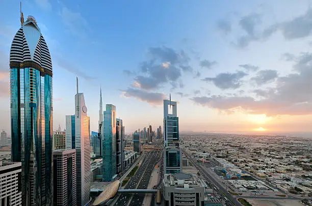 skyscrapers along Sheikh Zayed Road, Burj Khalifa and Burj Al Arab Hotel in Dubai United Arab Emirates at sunset