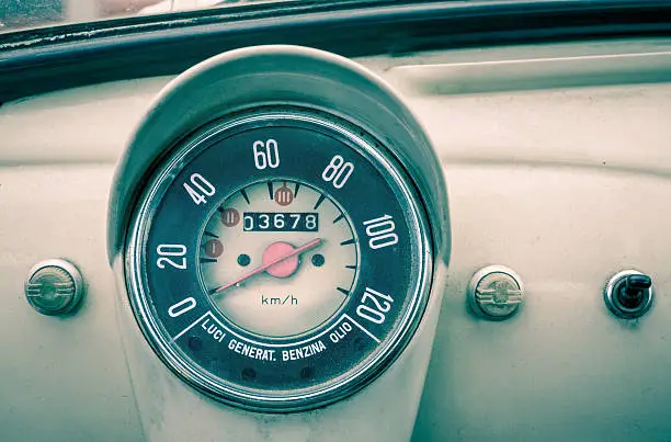 View on the vintage control panel and speedometer of an old classical Italian car.