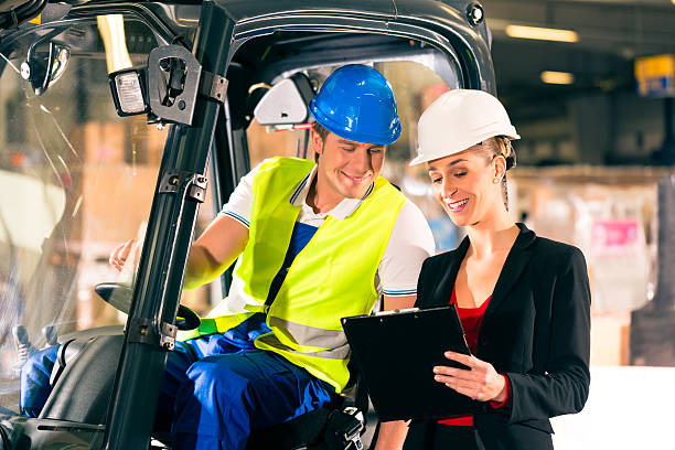 istock A forklift driver talking to a manager in the warehouse 163882414