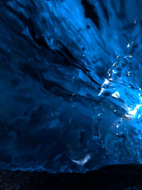 istock Glacial blue ice in ice cave 1638825709