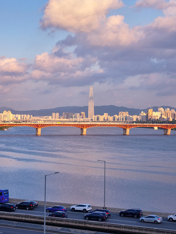 Portrait of rush hour in Seoul, Korea, with Han River and the iconic building at the background.