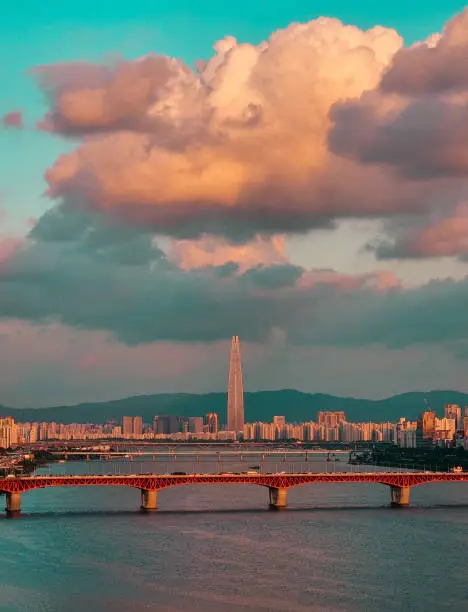 Portrait of Han River and buildings surrounding it, including Lotte World Tower, during sunset in Seoul, Korea.