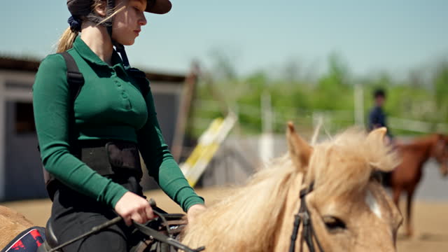 Girl jockey riding a small horse