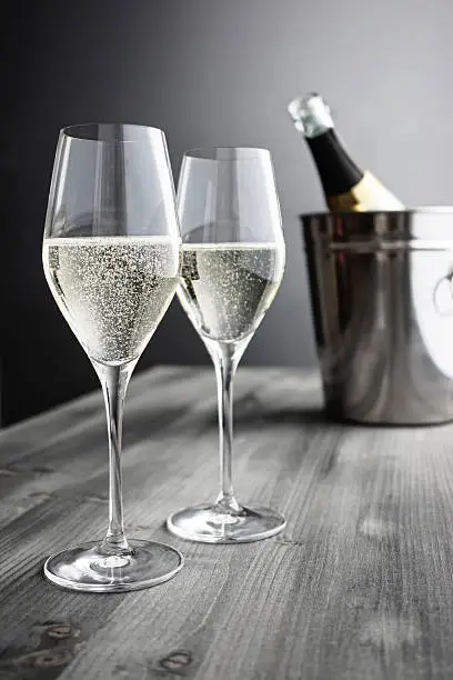Two glasses of Champagner, Bottle and Cooler; selective focus