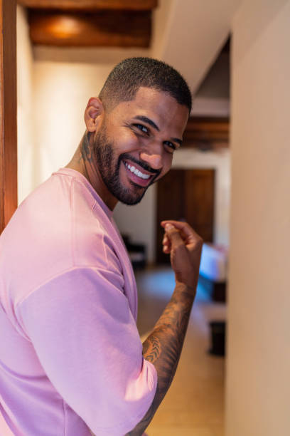 Tourist walks through the hotel on his trip which he makes alone and happy