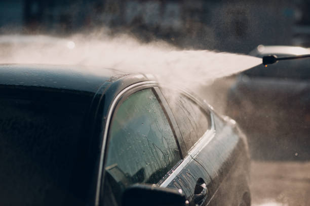 istock Worker washing car at self-service car wash 1639008111