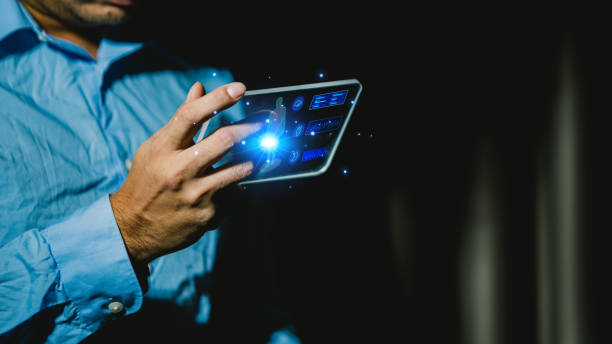 istock Businessman using tablet computer in dark room. Business and technology concept. 1639009543