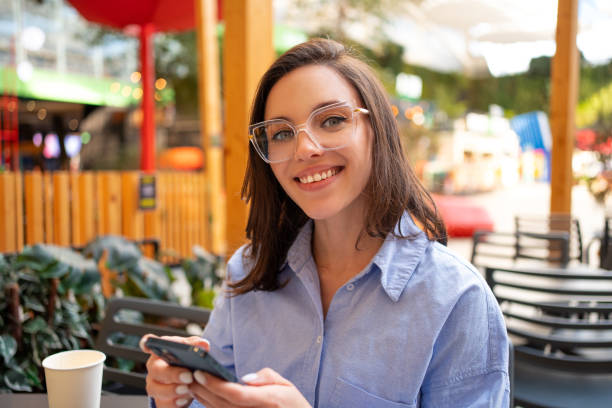 istock Woman using mobile phone at cafe 1639021322
