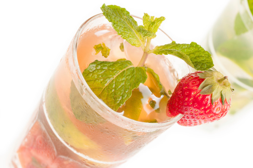 Mojito a Cuban cocktail made with cuban rum, lime, sugar, a splash of soda and flavoured with fresh strawberry juice