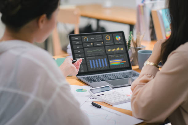 istock Two businesspeople or an accountant team are analyzing data charts, graphs, and a dashboard on a laptop screen in order to prepare a statistical report and discuss financial data in an office. 1639029491