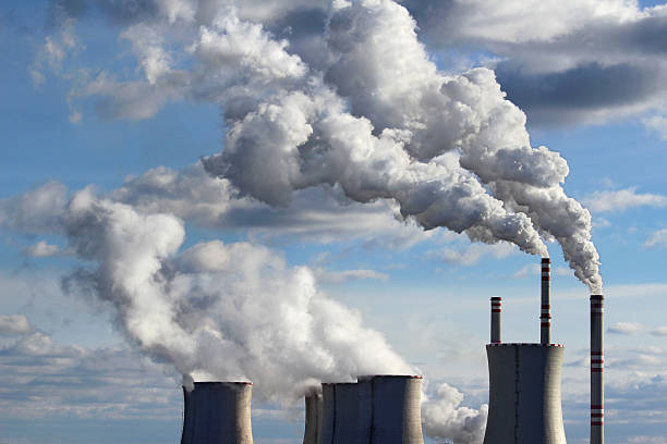 smoking cooling towers of coal power plant stock photo