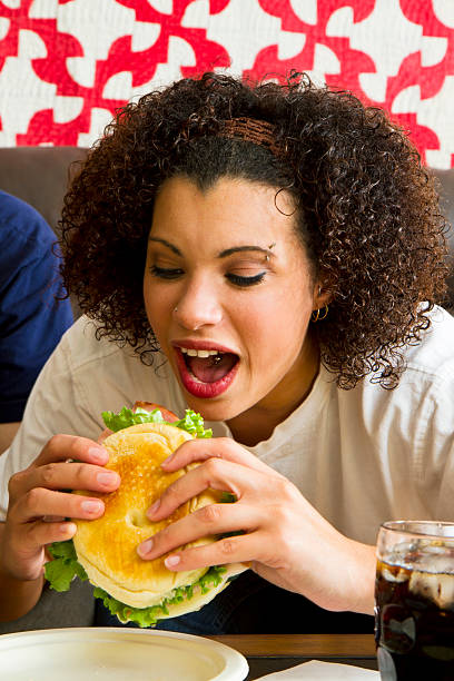 istock Young Woman Eating A Sandwich 163907032