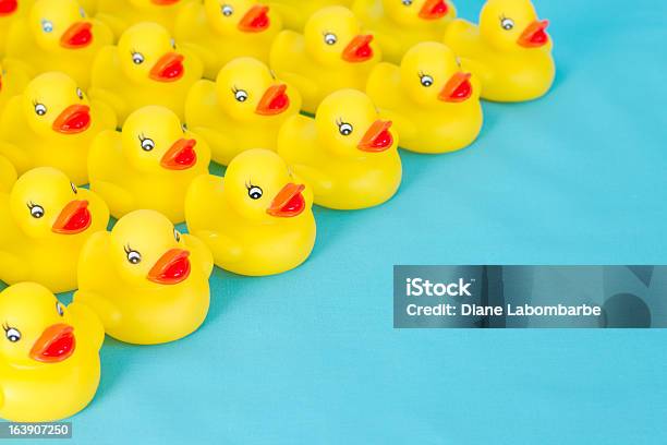Many Rows Of Yellow Rubber Ducks On Light Blue Background Stock Photo - Download Image Now