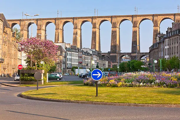 Large stone bridge in Morlaix town, Brittany, France at sunny evening