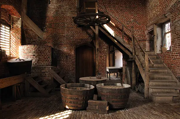 An authentic Tudor brewery with suitably aged and detailed red bricked walls and stone floors, complemented by an array of tools and equipment needed to make beer, a staple part of the diet in Medieval times.  Social history and heritage, Suffolk, England