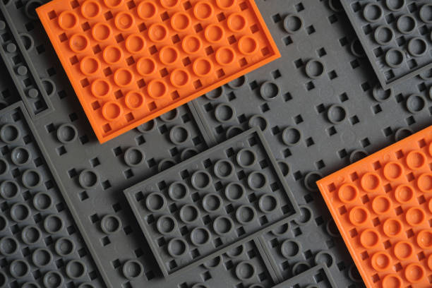 istock Abstract gray orange background from plastic building block children designer. 1639111561