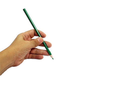 A green pencil in hand isolated on a white background with copy space, designer conceptual for creative.