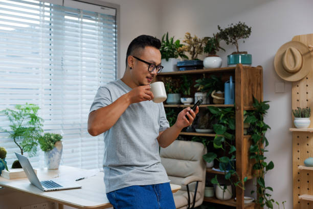 istock Asian men look at phone information while working from home 1639139546
