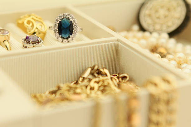 Jewelry box filled with rings and necklaces stock photo