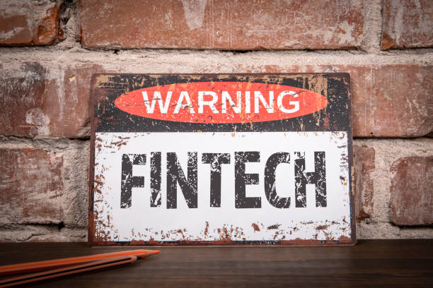 istock Fintech Concept. Warning sign on wooden texture office desk 1639158410