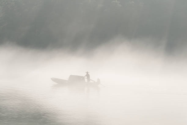 istock fishermen in the fog preparing to fish 163918174