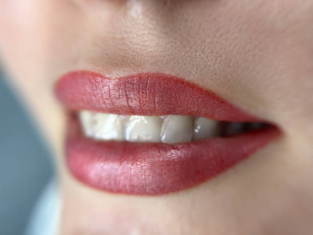 istock permanent womans lips tattoo close up, lipstick effect make up, the lips after a tattoo with a coloring pigment 1639186430
