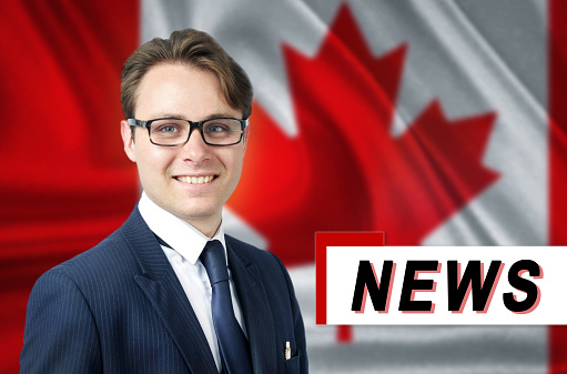 News anchor, tells the latest news, smiling, against the background of the flag of Canada. Media and propaganda.
