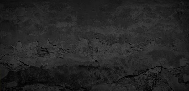 istock Texture of an old black brick wall 1639203396