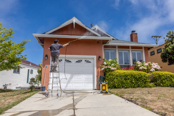 Power Washing Home High quality stock photo of a middle aged man power washing a single-family home. Power Washing stock pictures, royalty-free photos & images